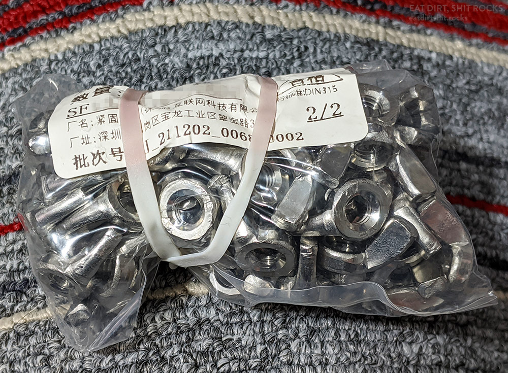 A typical baggie of fasteners. Mark the fading of the ink on the label and the pinkish hue that has developed in only those areas of the white silicone rubber band that have been in contact with the thermal printer label.